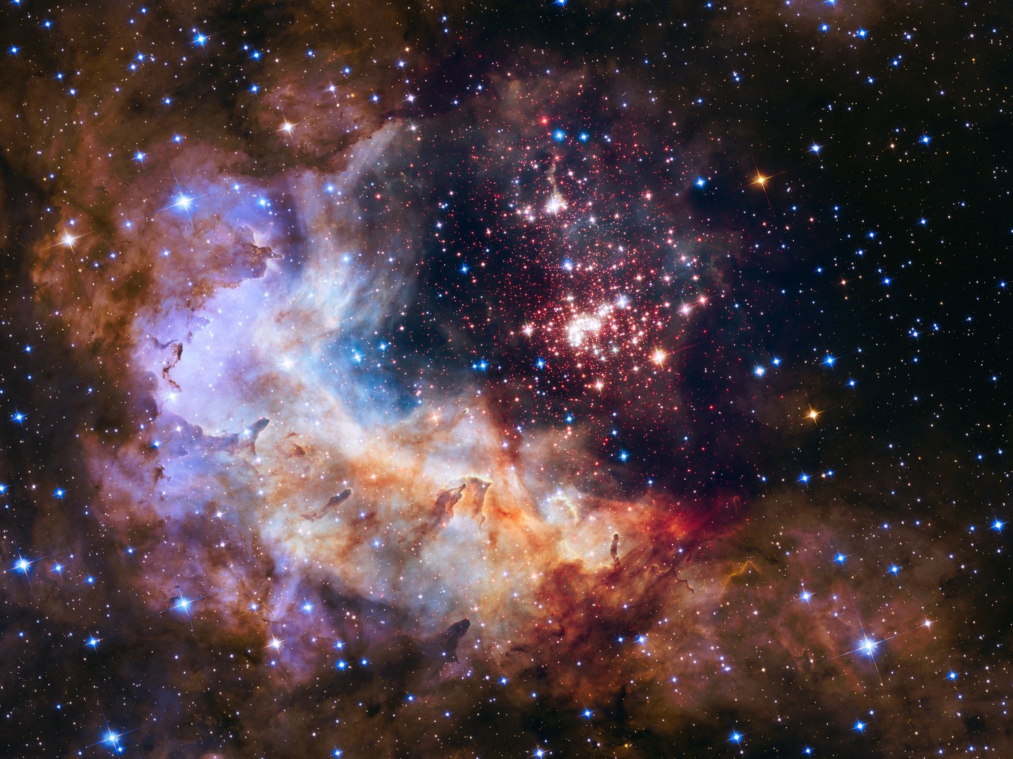 The stunning display of celestial bodies in this remarkable image is Westerlund 2, named after the renowned Swedish astronomer, Bengt Westerlund, who first observed it. This cluster of over 3,000 stars spans a vast distance of 6 to 13 light-years and has an age of approximately 2 million years - a relatively short period in the life of a star. As we gaze upon this young star cluster, we can see the red specks that represent newborn stars still  Source : Instagram @nasa